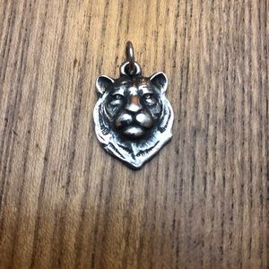 Retired lions head charm